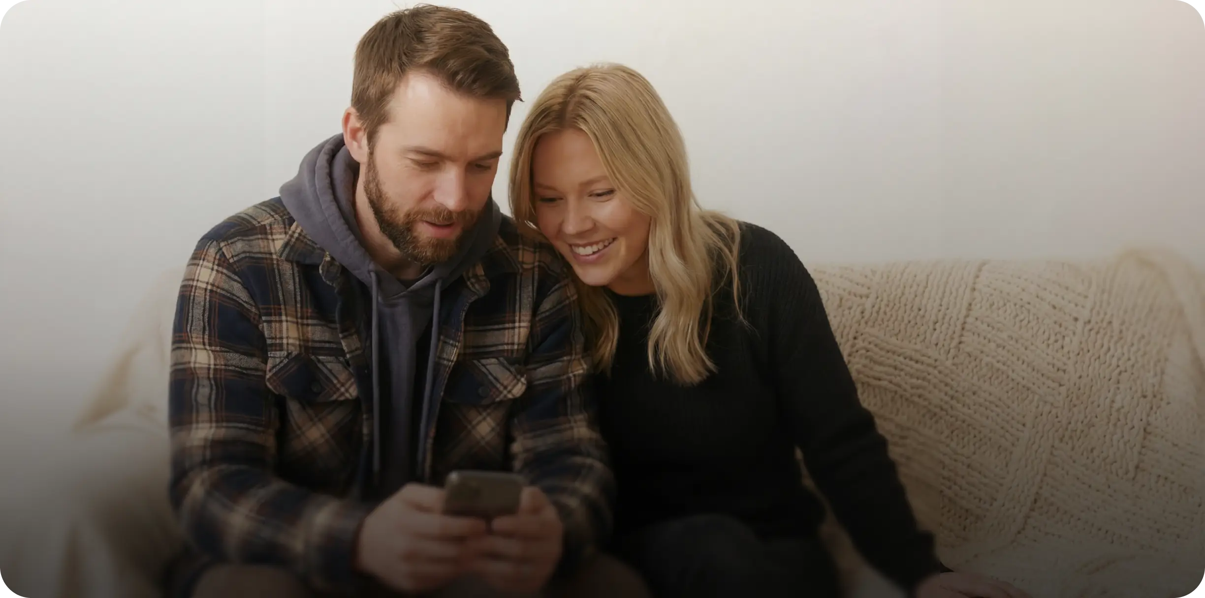 Couple smiling together on a couch
